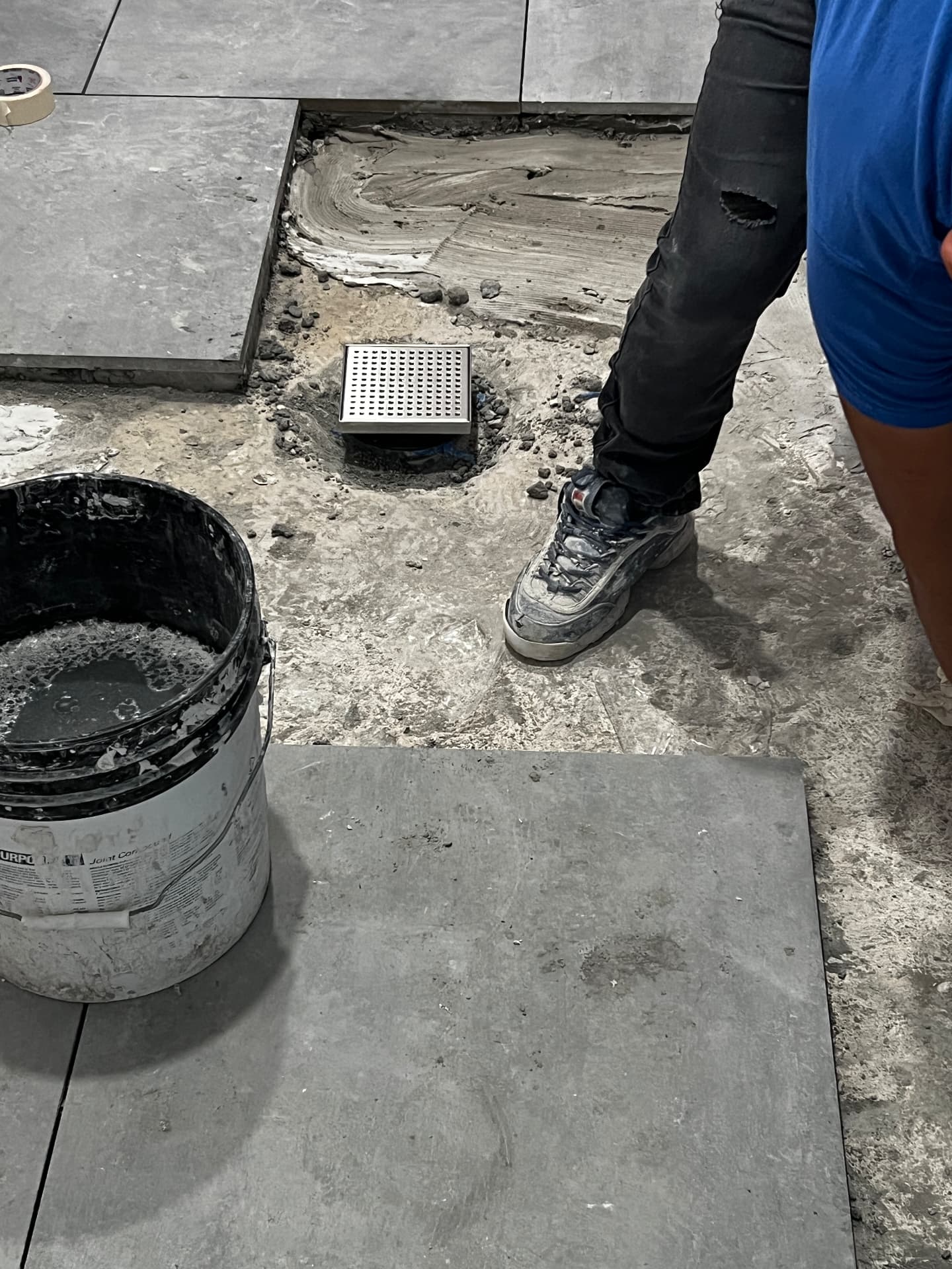 Large-format tile with linear floor drain